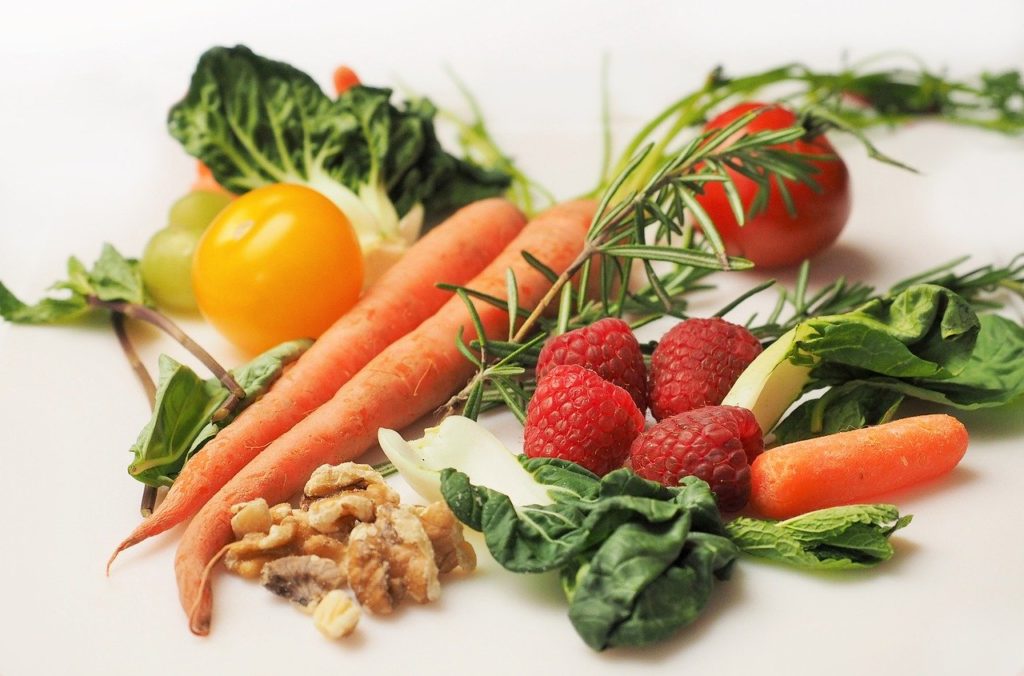 Dieta seniora, warzywa i owoce na stole marchewka, maliny zielenina